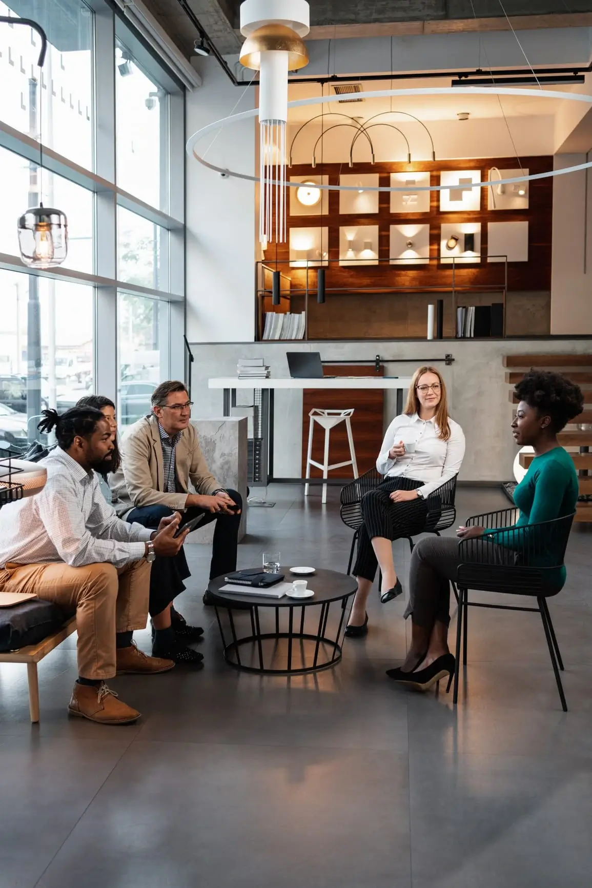 African woman talking to a group of business people in a job interview.